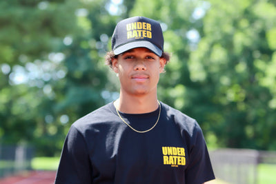BLACK UNDERRATED TRUCKER HAT WITH YELLOW FONT